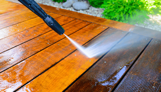 Pressure washing of a wooden deck brings back original color after the years turn the wood black